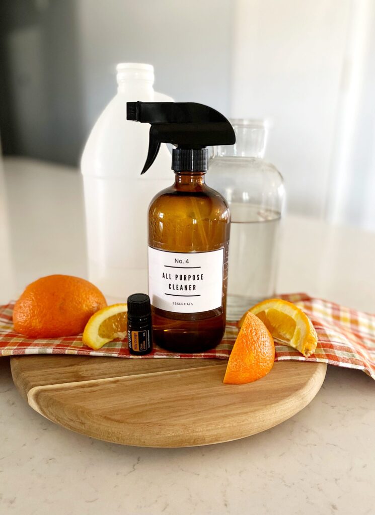 Amber spray bottle with label that reads: All Purpose Cleaner - essential oil, oranges, and other ingredient to make homemade cleaning recipes