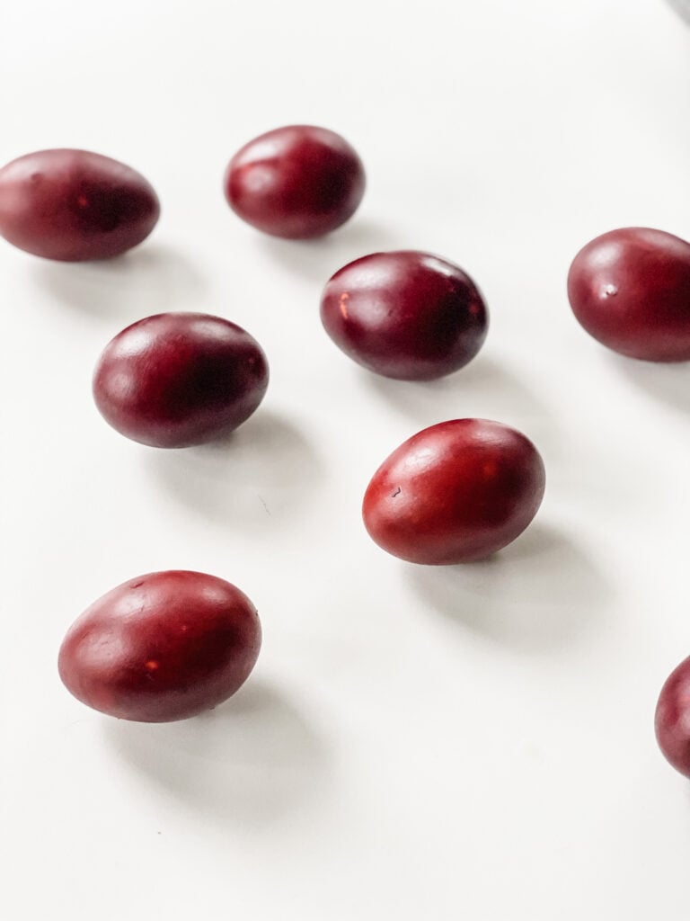 Eggs on a tabletop - dyed red from onion skins using the haminados cooking technique
