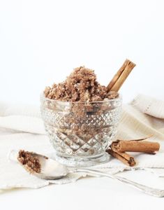brown sugar and cinnamon sticks in a glass bowl on tabletop - ingredients for brown sugar and cinnamon sugar scrub