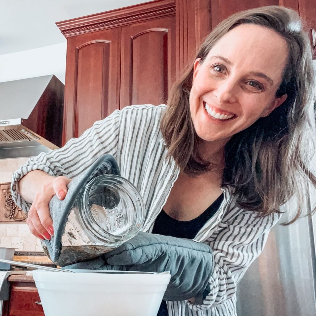 Julia Linsteadt making herbal infused oils in her kitchen.
