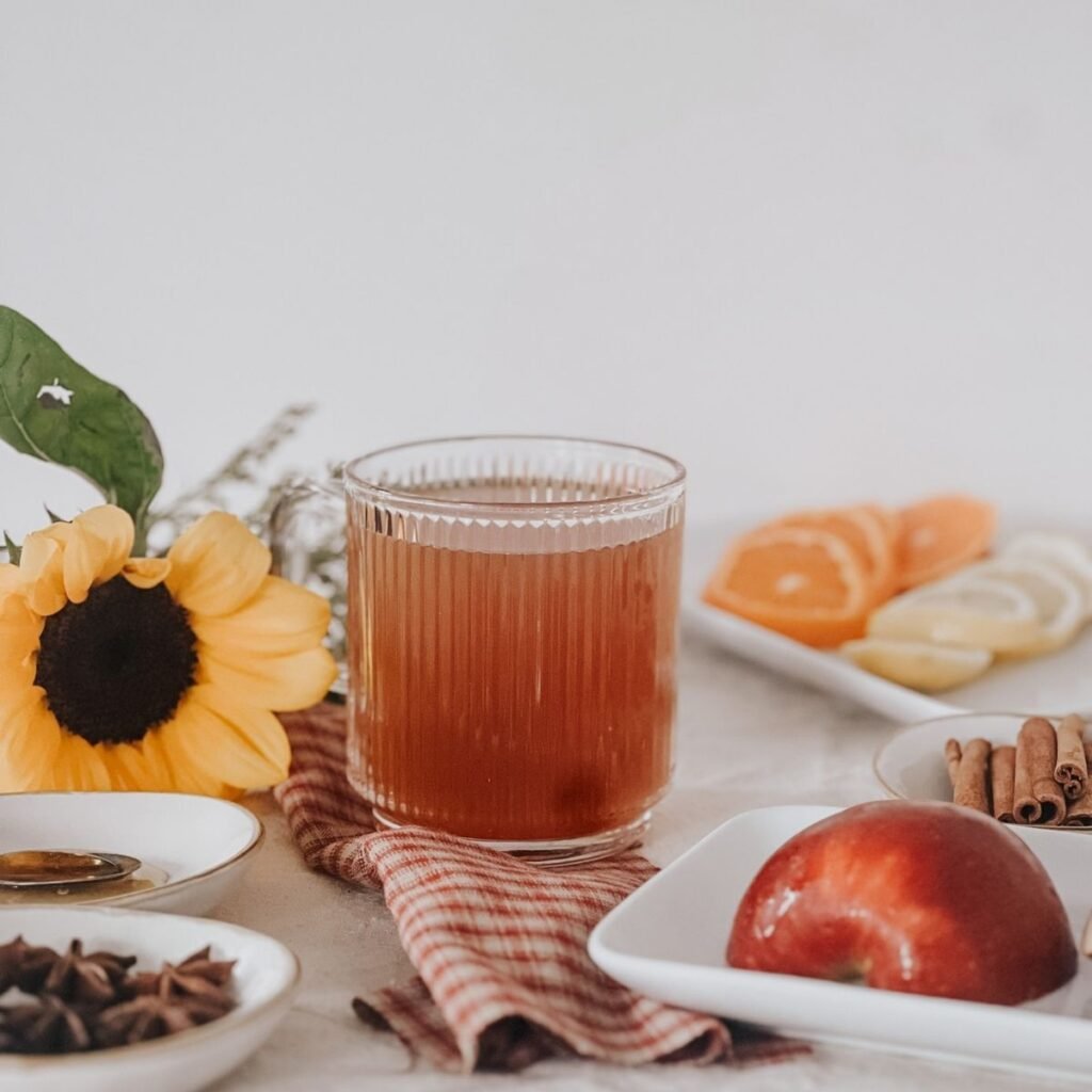 Image of the herbal apple cider made in a slow cooker up close in a glass mug.