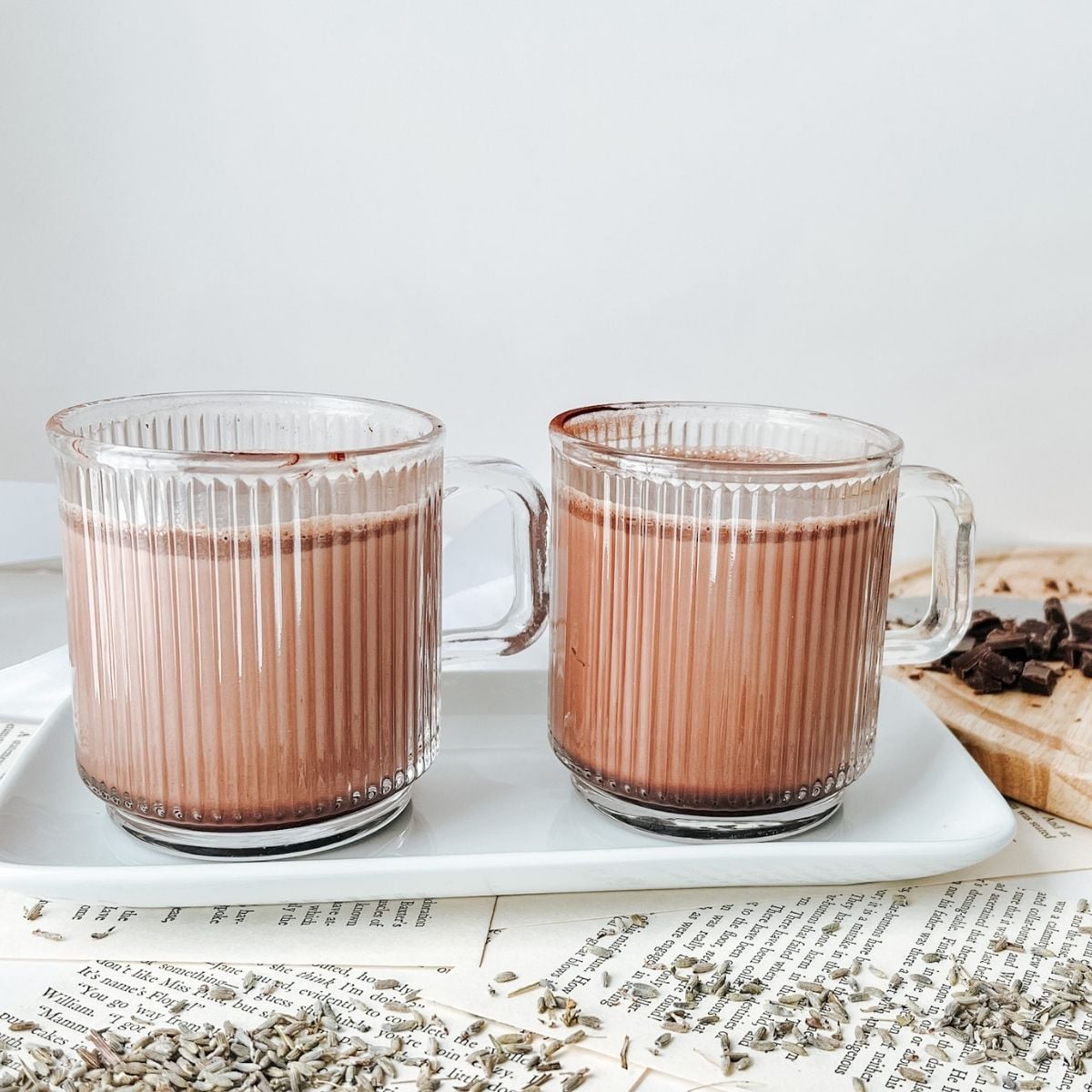 Two glass mugs that contain lavender infused hot chocolate.